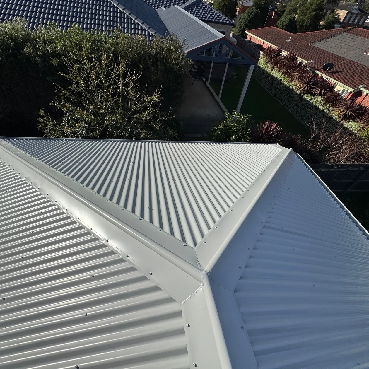 Corrugated metal hip roof on a suburban home