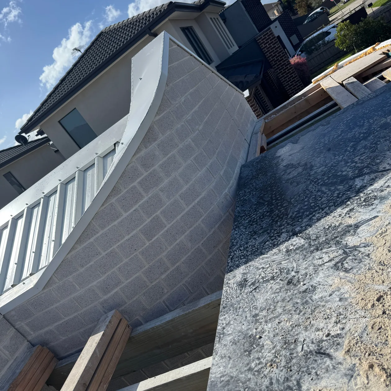 Curved upper wall prepared for cladding during construction, work in progress