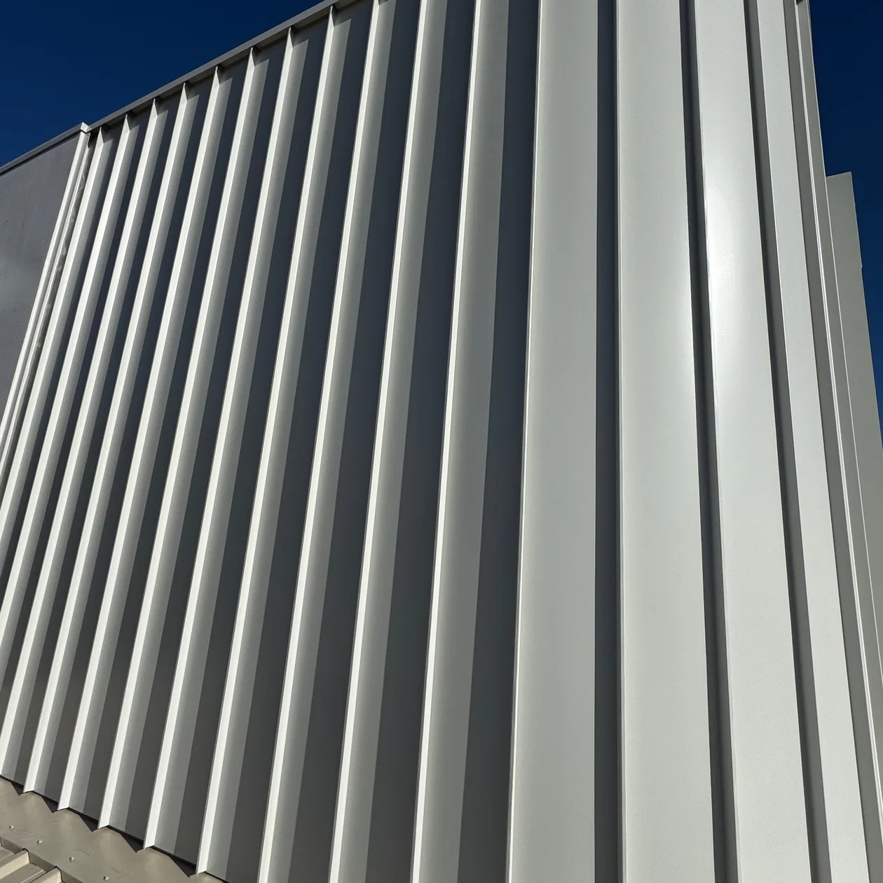 Curved metal cladding on the upper storey of a home