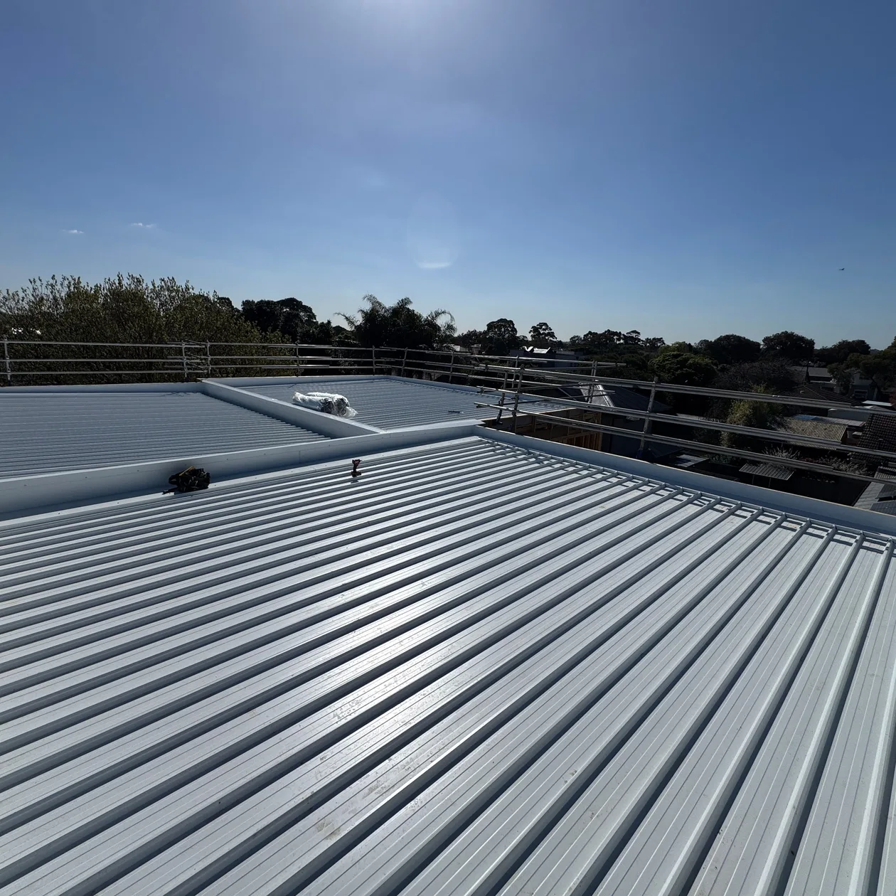 Long pale low-pitch metal roof