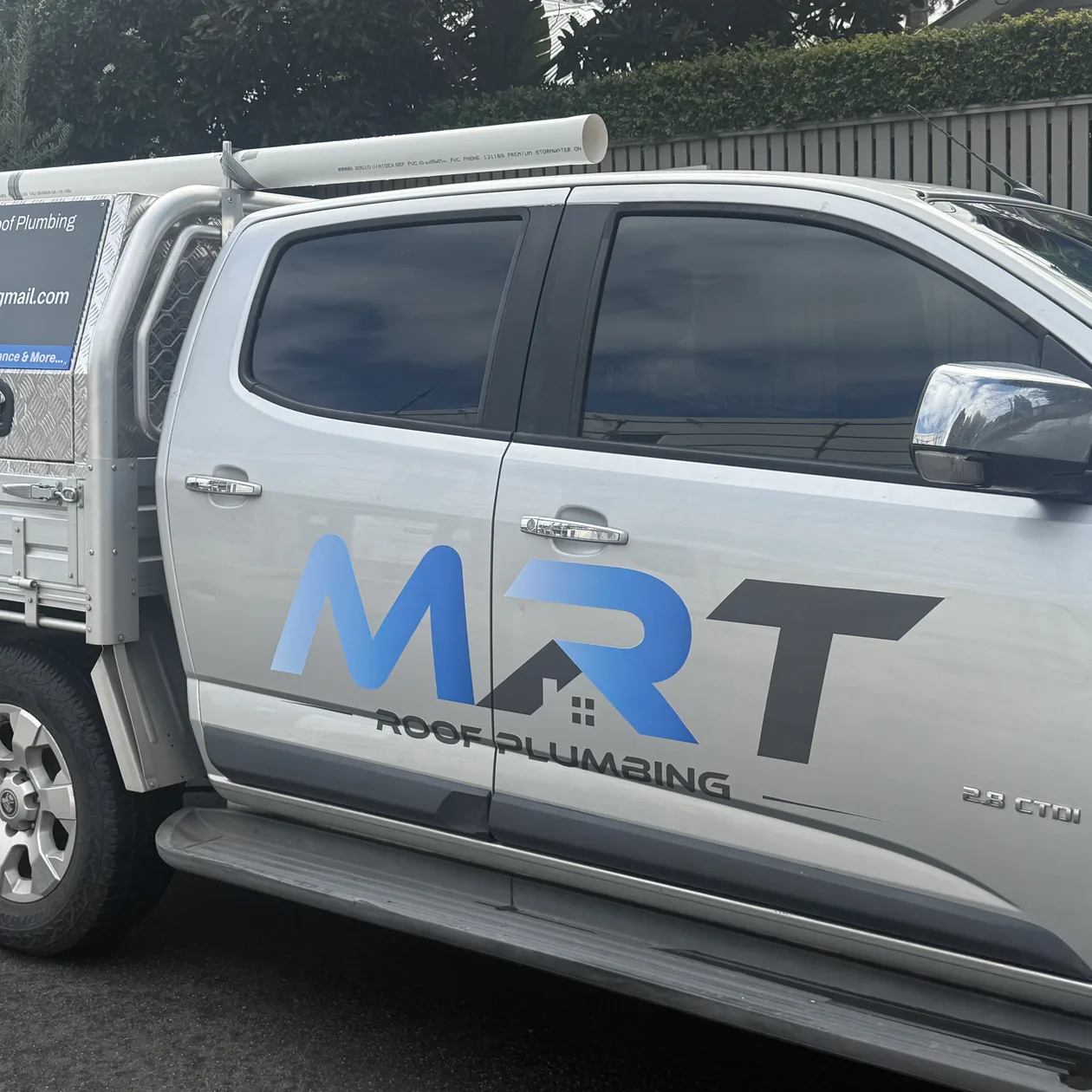 MRT Roof Plumbing branded work ute parked on a suburban street