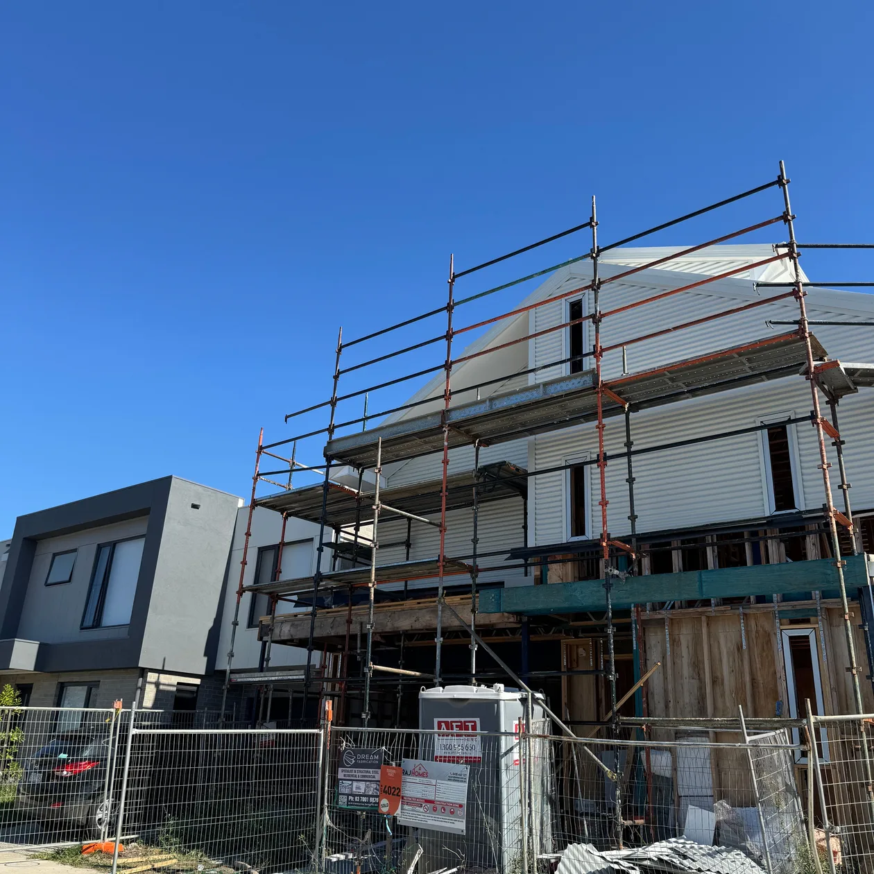 New two-storey home under construction with scaffolding around it, work in progress