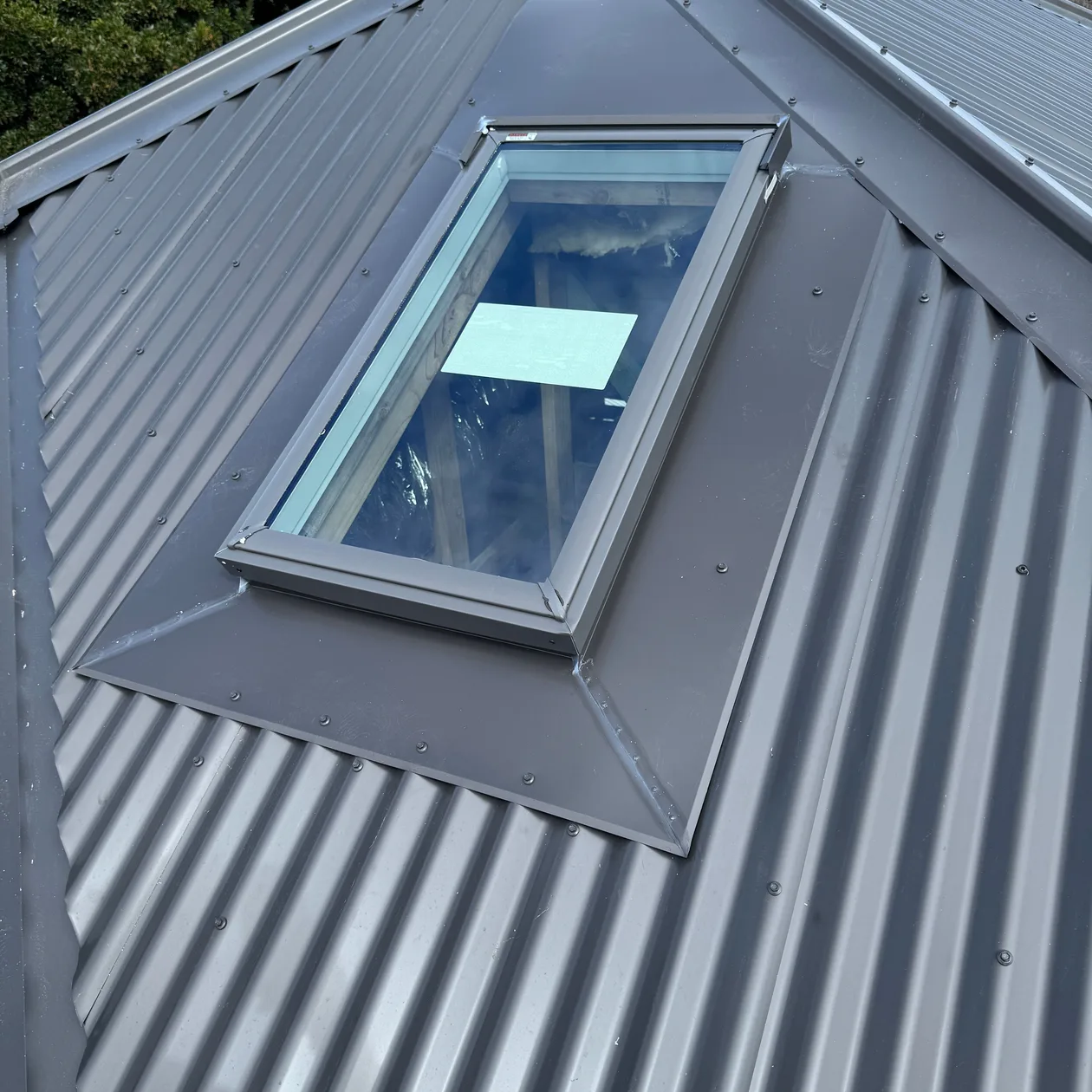 Metal flashing around a roof window on a metal roof