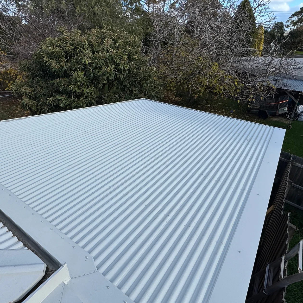 Pale corrugated metal hip roof